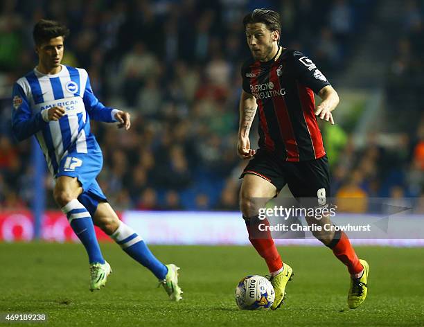 Harry Arter of Bournemouth is watched by Joao Carlos Teixeira of Brighton and Hove Albion during the Sky Bet Championship match between Brighton &...