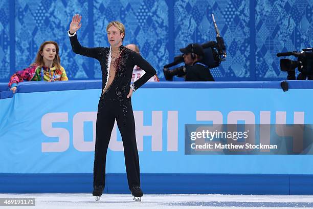 Evgeny Plyushchenko of Russia waves to fans as he withdraws from the competition after warm up during the Men's Figure Skating Short Program on day 6...