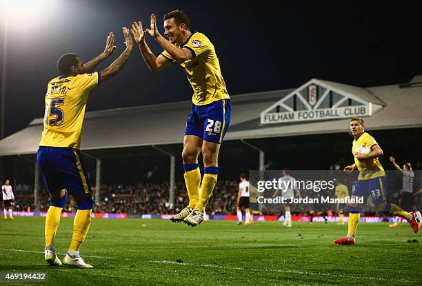 Jason Pearce of Wigan Athletic celebrates with Jermaine Pennant as he scores their second goal during the Sky Bet Championship match between Fulham...