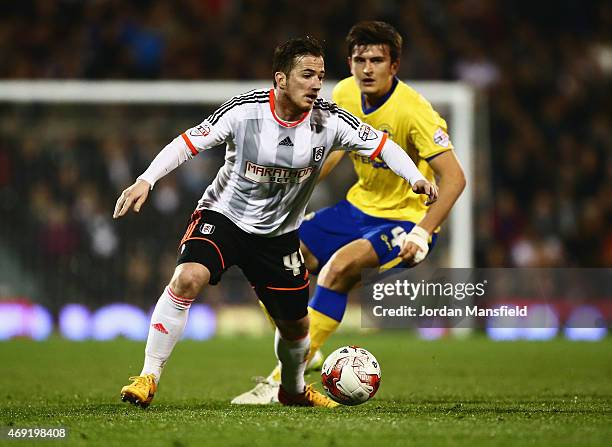 Ross McCormack of Fulham holds off Harry Maguire of Wigan Athletic during the Sky Bet Championship match between Fulham and Wigan Athletic at Craven...