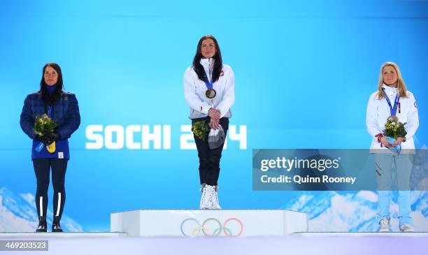 Silver medalist Charlotte Kalla of Sweden, gold medalist Justyna Kowalczyk of Poland and bronze medalist Therese Johaug of Norway celebrate during...