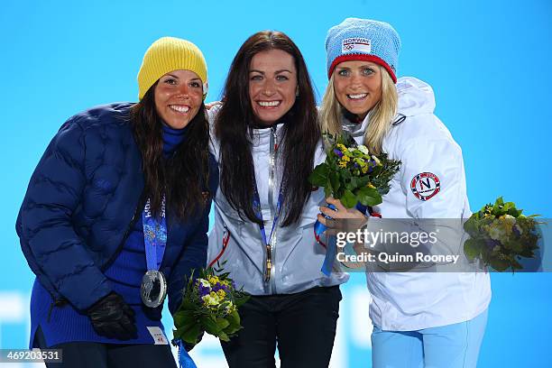 Silver medalist Charlotte Kalla of Sweden, gold medalist Justyna Kowalczyk of Poland and bronze medalist Therese Johaug of Norway celebrate during...