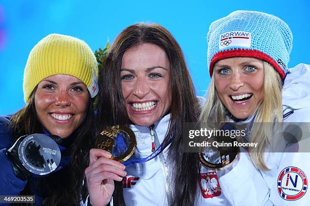 Silver medalist Charlotte Kalla of Sweden, gold medalist Justyna Kowalczyk of Poland and bronze medalist Therese Johaug of Norway celebrate during...