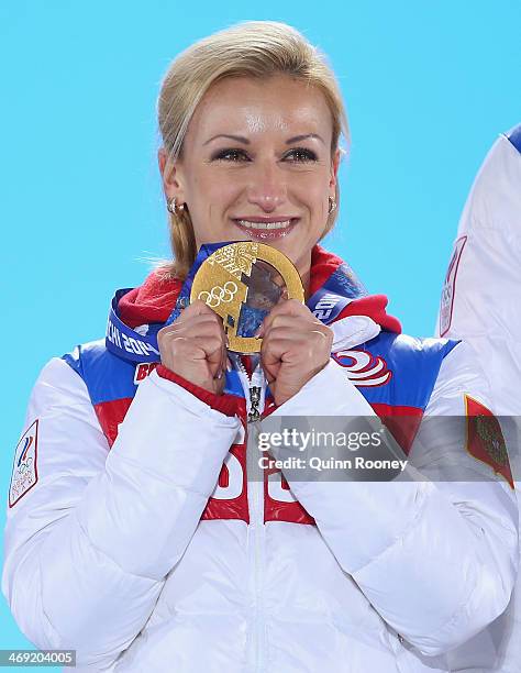 Gold medalists Tatiana Volosozhar of Russia celebrates during the medal ceremony for the Figure Skating Pairs Free Skating on day six of the Sochi...