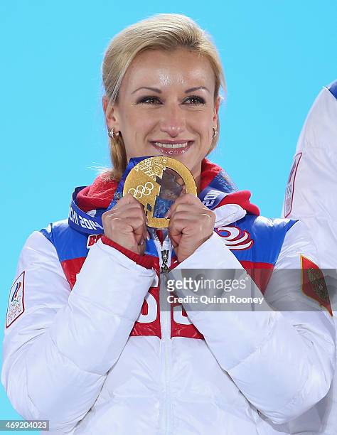 Gold medalists Tatiana Volosozhar of Russia celebrates during the medal ceremony for the Figure Skating Pairs Free Skating on day six of the Sochi...