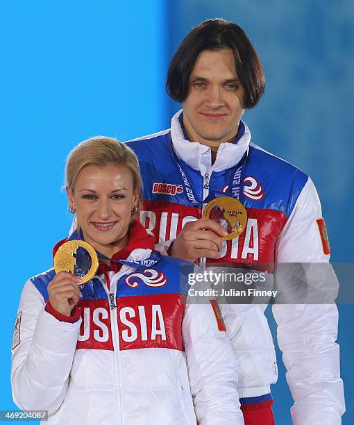 Gold medalists Tatiana Volosozhar and Maxim Trankov of Russia celebrate during the medal ceremony for the Figure Skating Pairs Free Skating on day...