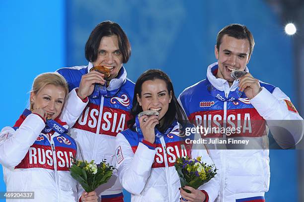 Gold medalists Tatiana Volosozhar and Maxim Trankov of Russia and silver medalists Ksenia Stolbova and Fedor Klimov of Russia celebrate during the...