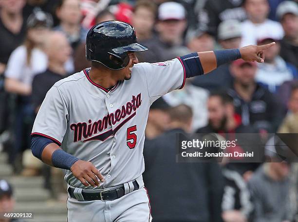 Eduardo Escobar of the Minnesota Twins points to the Chicago White Sox dugout after scoring a run in the 5th inning on a wild pitch during the White...