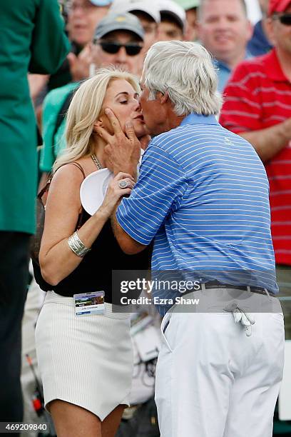 Ben Crenshaw of the United States kisses his wife Julie behind the 18th green after playing his final Masters during the second round of the 2015...