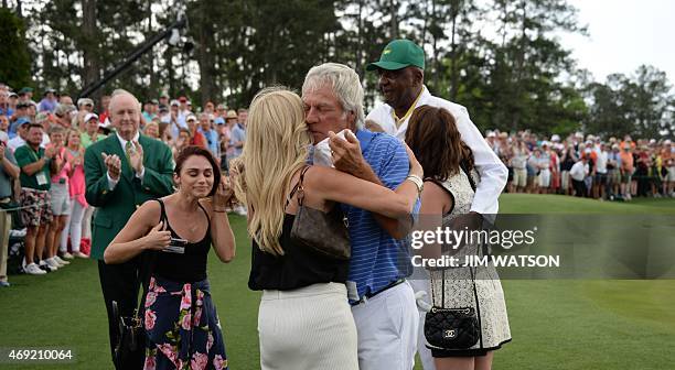 Ben Crenshaw of the US hugs his wife after finishing the 18th hole during Round 2 of the 79th Masters Golf Tournament at Augusta National Golf Club...