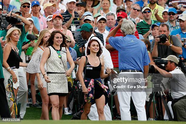 Ben Crenshaw of the United States is greeted by his wife Julie and their daughters behind the 18th green after playing his final Masters during the...