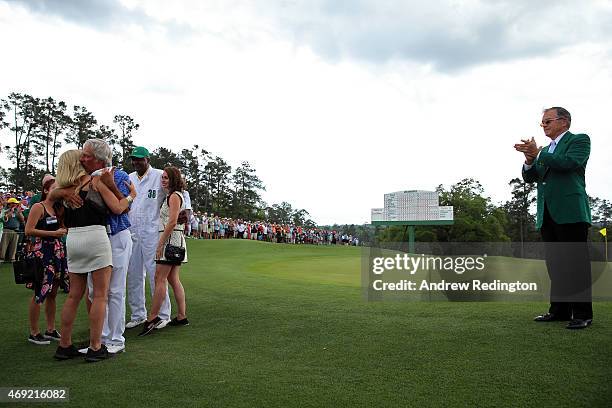 Ben Crenshaw of the United States waits with his wife Julie, their family and longtime caddie Carl Jackson as William Porter Payne, Chairman of...