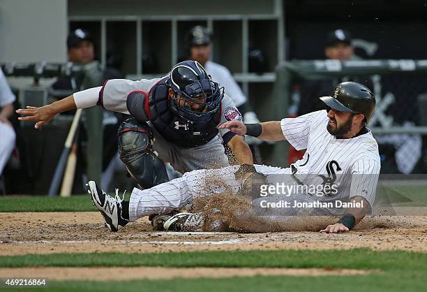 Adam Eaton of the Chicago White Sox is tagged out at the plate by Kurt Suzuki of the Minnesota Twins for the final out of the game during the White...