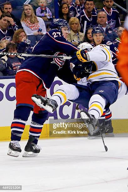 Ryan Murray of the Columbus Blue Jackets checks Patrick Kaleta of the Buffalo Sabres while skating after the puck during the first period on April...