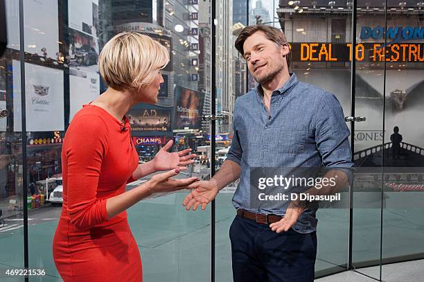 Charissa Thompson interviews Nikolaj Coster-Waldau during his visit to "Extra" at their New York Studios at H&M in Times Square on April 10, 2015 in...