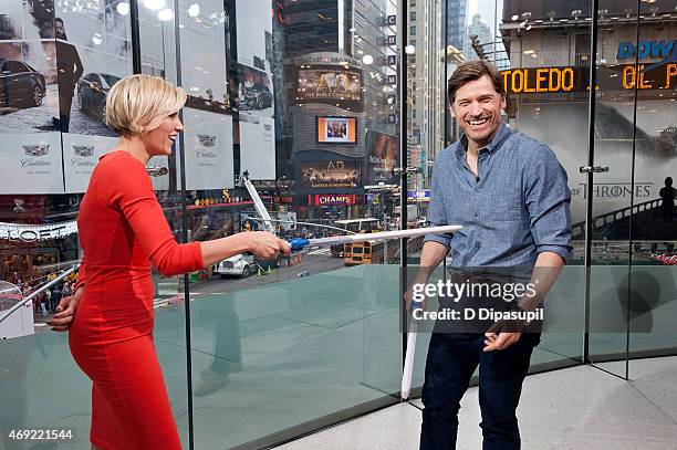 Charissa Thompson interviews Nikolaj Coster-Waldau during his visit to "Extra" at their New York Studios at H&M in Times Square on April 10, 2015 in...