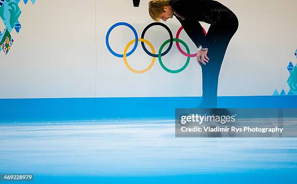 Evgeny Plyushchenko of Russia reacts after his injury at a warm up during the Men's Figure Skating Short Program on day 6 of the Sochi 2014 Winter...
