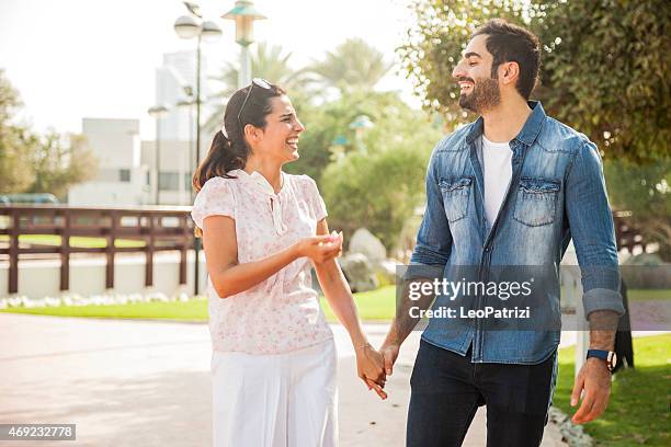 young couple enjoying life outdoor in a city park - arab couple stock pictures, royalty-free photos & images