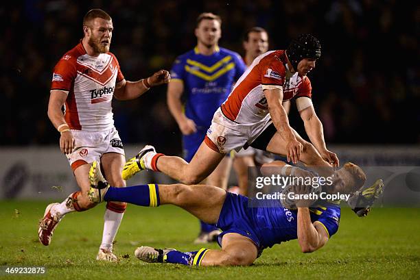 James Laithwaite of Warrington Wolves is tackled by Jonny Lomax of St Helens during the Super League match between Warrington Wolves and St Helens at...