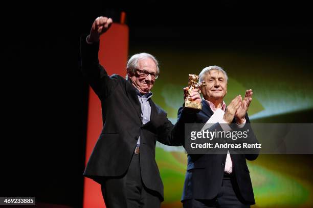 Ken Loach receives his Honoray Golden Bear next to director Jiri Menzel during the 64th Berlinale International Film Festival at Berlinale Palast on...