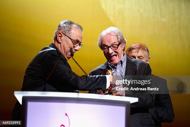 Ken Loach receives his Honoray Golden Bear next to festival director Dieter Kosslick during the 64th Berlinale International Film Festival at...