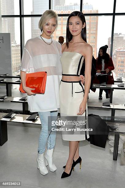 Soo Joo Park and Tao Okamoto attend the Calvin Klein Collection fashion show during Mercedes-Benz Fashion Week Fall 2014 at Spring Studios on...