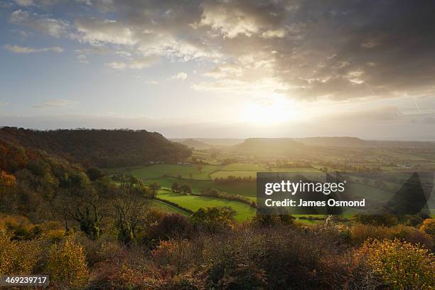 sun setting over cam long down - gloucestershire autumn stock pictures, royalty-free photos & images