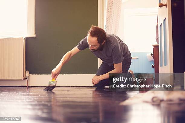 man painting wooden floor - christopher guy stock pictures, royalty-free photos & images