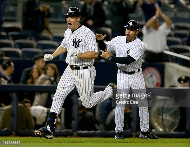 Chase Headley of the New York Yankees celebrates his solo home run as he runs by Joe Espada in the ninth inning against the Boston Red Sox on April...
