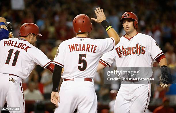 Paul Goldschmidt of the Arizona Diamondbacks high-fives A.J. Pollock and Ender Inciarte at home plate after hitting a three-run home run against the...