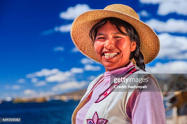 portrait of happy woman on uros floating island, lake tititcaca - peruvian culture stockfoto's en -beelden
