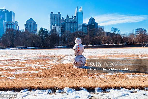 a snowman in piedmont park, atlanta - melting snowman stock pictures, royalty-free photos & images