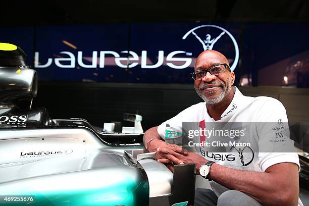 Laureus Sport for Good Foundation Chairman Edwin Moses poses with the car belonging to Nico Rosberg of Germany and Mercedes GP during a Laureus...