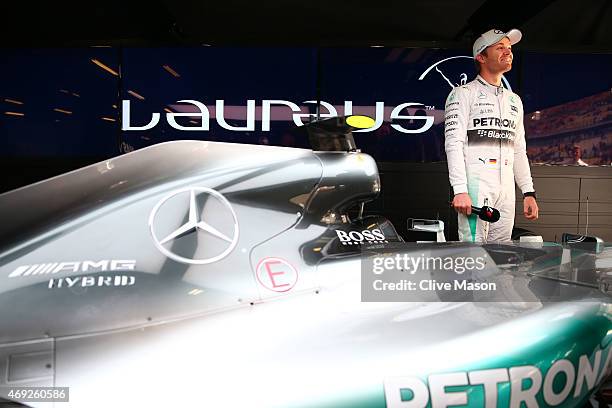 Nico Rosberg of Germany and Mercedes GP stands next to the F1 W06 in the team garage during a Laureus photocall ahead of the Chinese F1 Grand Prix at...