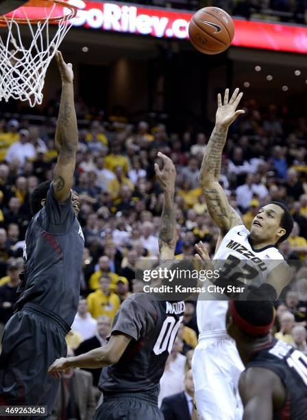 Missouri Tigers' Jabari Brown puts up a go-ahead bucket over Arkansas Razorbacks' Coty Clarke, left, and Rashad Madden at Mizzou Arena in Columbia,...