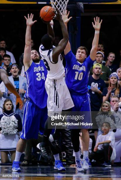 Khyle Marshall of the Butler Bulldogs shoots the ball against the double team of Ethan Wragge and Grant Gibbs of the Creighton Bluejays at Hinkle...