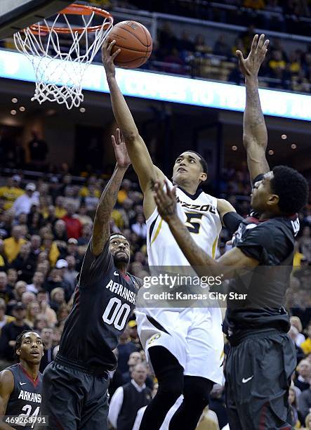 Missouri Tigers' Jordan Clarkson, who led the way with a game-high 27 points, elevates over Arkansas' Rashad Madden and Coty Clarke during the second...