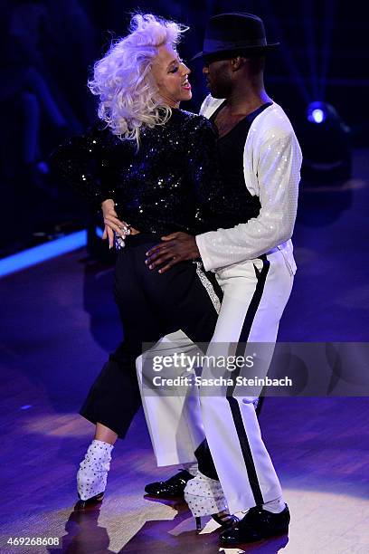 Hans Sarpei and Kathrin Menzinger perform on stage during the 4th show of the television competition 'Let's Dance' on April 10, 2015 in Cologne,...