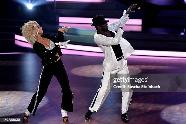 Hans Sarpei and Kathrin Menzinger perform on stage during the 4th show of the television competition 'Let's Dance' on April 10, 2015 in Cologne,...