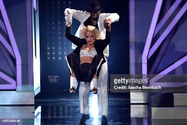 Hans Sarpei and Kathrin Menzinger perform on stage during the 4th show of the television competition 'Let's Dance' on April 10, 2015 in Cologne,...