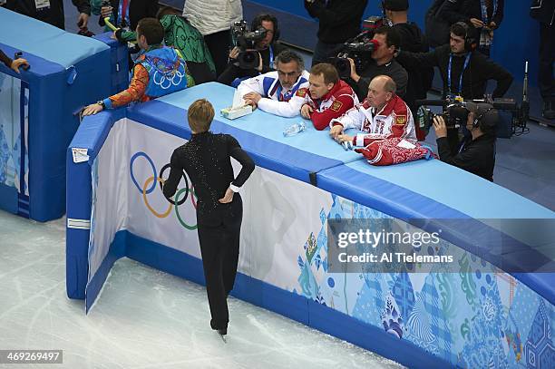 Winter Olympics: Rear aerial view of Russia Evgeny Plushenko during injury warming up and talking with coaching crew before Men's Short Program at...