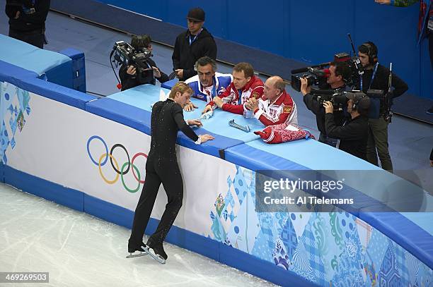 Winter Olympics: Aerial view of Russia Evgeny Plushenko during injury warming up and talking with coaching crew before Men's Short Program at Iceberg...