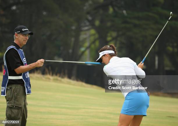 Jaclyn Sweeney of the USA practices her swing with her caddy as she prepares to play a shot on the 2nd hole during the second round of the ISPS Handa...