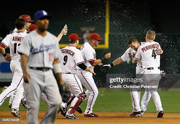 Ender Inciarte of the Arizona Diamondbacks is congratulated by David Peralta and Cliff Pennington after Inciarte hit a walk off RBI single against...