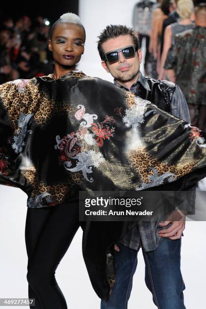 Designer Erik 'Mister Triple X' Rosete and a model walk the runway at the FLT Moda + Art Hearts Fashion show presented by AIDS Healthcare Foundation...