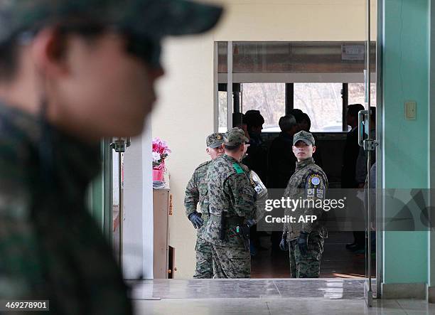 Army soldiers stand guard during a graduation ceremony of Taesungdong Elementary School at Taesungdong freedom village near the border village of...