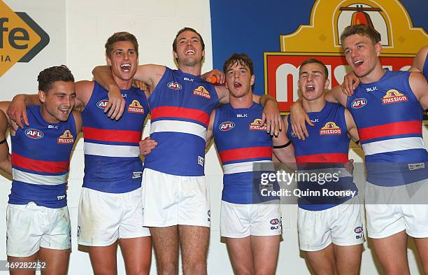 Luke Dahlhaus, Michael Talia, Ayce Cordy, Liam Picken, Mitch Honeychurch and Jackson Macrae of the Bulldogs sing the song in the rooms after winning...