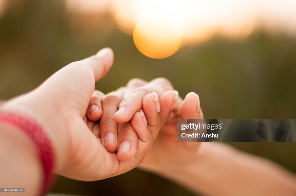 Holding hands during sunset