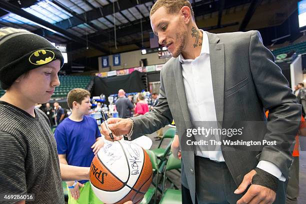 Texas Legends basketball player Delonte West takes time at the end of the game to sign autographs for fans at the Dr. Pepper Arena on April 1, 2015...