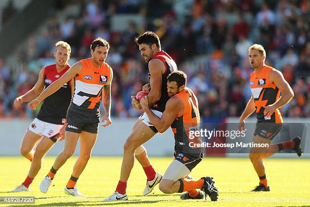 Chris Dawes of the Demons is tackled during the round two AFL match between the Greater Western Sydney Giants and the Melbourne Demons at Startrack...